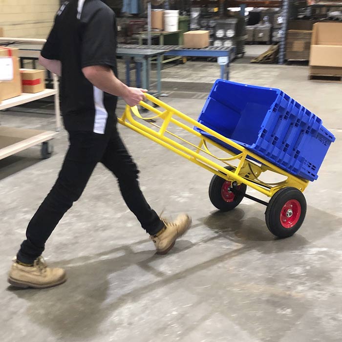 Hand truck carrying boxes in a warehouse